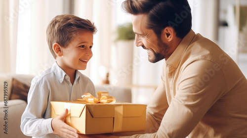 Happy father's day card. Son congratulating his daddy giving him a present at home. Happy birthday. Happy little boy holds a gift box and looks at father. Family holiday celebration, relationship © Dina Photo Stories