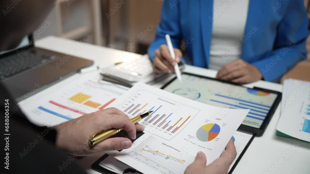 Two investors analyze and write financial data and business reports together, plan strategies and brainstorm at the office together. Finance and Economy business idea