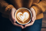Female Hands Cradle a Cup of Velvety Latte - A Cozy Moment of Warmth and Relaxation.
