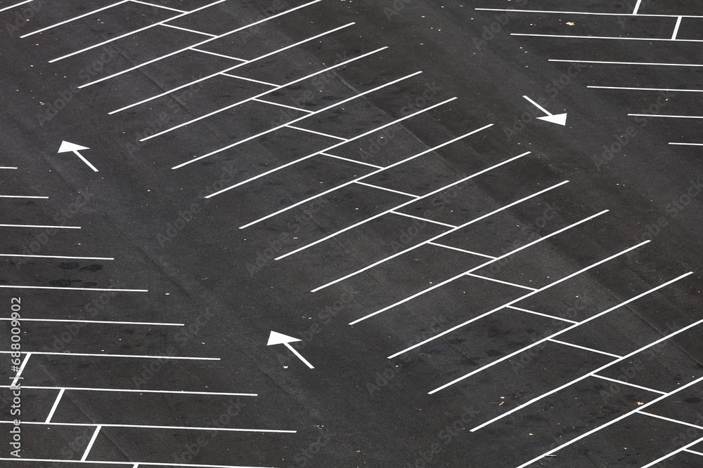 Empty parking space. Aerial photo with an asphalt parking lot in front of a shopping center and office buildings. Transportation industry.