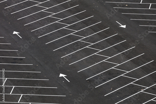 Obraz na płótnie Empty parking space. Aerial photo with an asphalt parking lot in front of a shopping center and office buildings. Transportation industry. w salonie