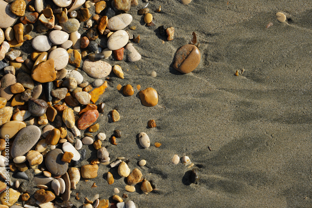 Pebbles on the seashore in close-up. A rocky beach. Rocks and sand in close-up. The natural background. Winter by the sea in the Mediterranean Pebbles on the seashore in close-up. A rocky beach. Rocks and sand in close-up. The natural background. Winter by the sea in the Mediterranean
