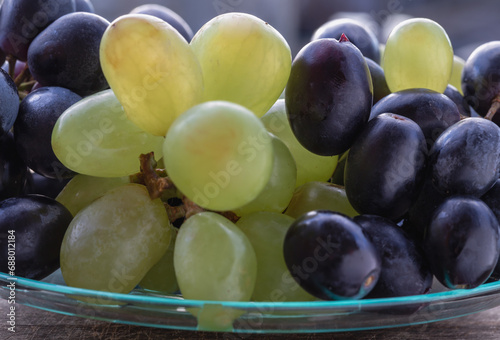 Close-up of Fresh Green seedless and Black seedless Grapes. grapes healthy fruit ready to eat, Space for text, Selective focus.