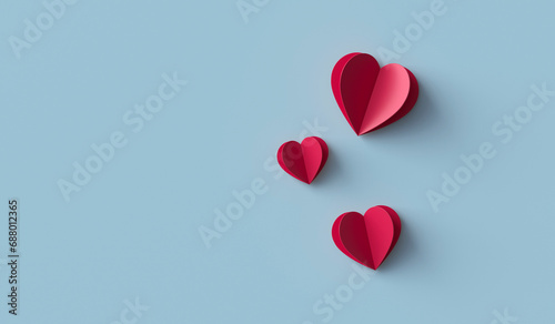 Red paper hearts on blue background photo