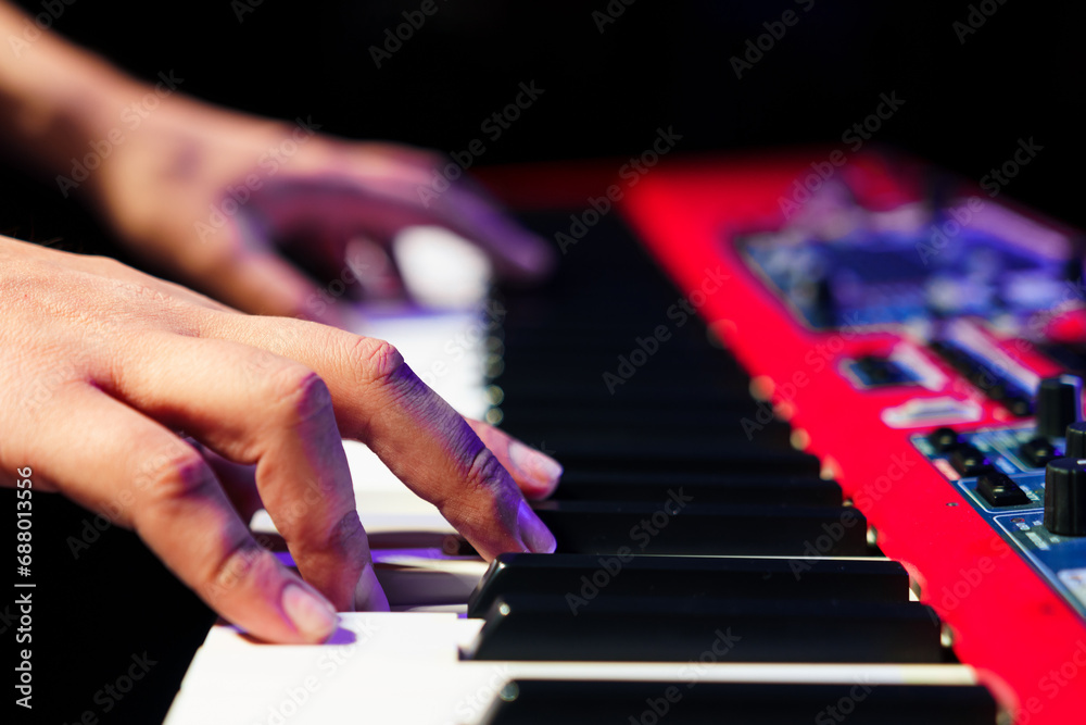 Close-up of a pianist's hands on an electronic synthesizer. Close-up of a pianist's hands on an electronic synthesizer.