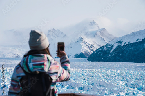 Woman photographing mountains at Los Glaciares National Park in Argentina photo