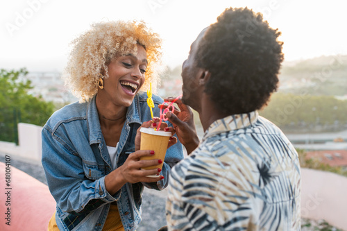 Happy transgender woman having juice with boyfriend photo