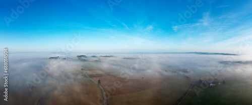 Austria, Upper Austria,Drone panorama of rural landscape shrouded in thick morning fog