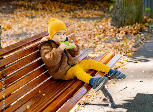 A Serene Moment: A Small Child Finding Peace and Joy on a Rustic Wooden Bench. A small child sitting on a wooden bench