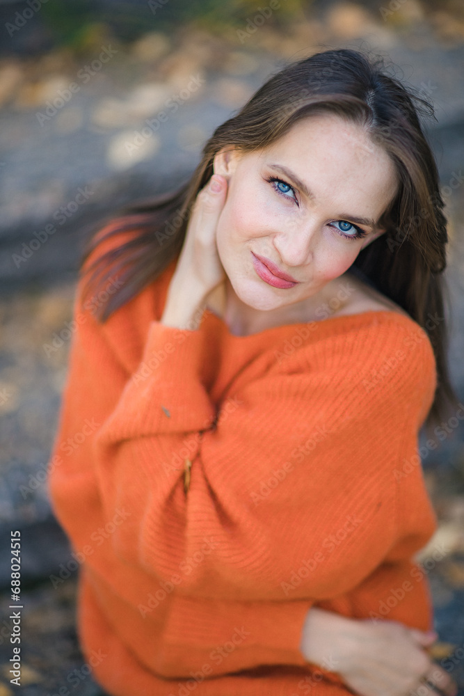 Portrait of an attractive brunette woman walking in the park at fall on a sunny day and smiling. The face of a happy beautiful woman in autumn outdoor. Portrait of an attractive brunette woman walking in the park at fall on a sunny day and smiling. The face of a happy beautiful woman in autumn outdoor.