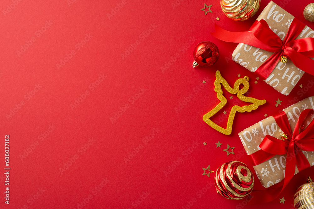 Festive cheer and belief arrangement. Top view of elegant handmade paper presents, luxurious baubles, shimmering angel decor, golden confetti on red backdrop with designated area for advertising text