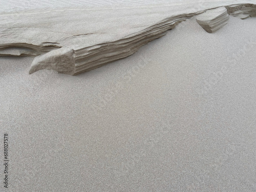 Close-up view of a natural accumulation of sand shaped by wind and water.