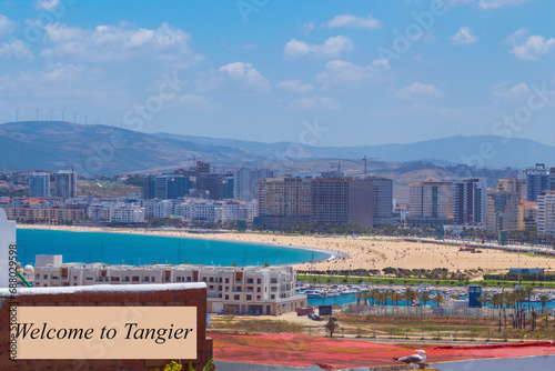 Advertising panoramic view of the beach with the ocean from a height with the inscription Welcome to Tangier, to advertise tourist holidays in the resorts of the city, Morocco, Africa