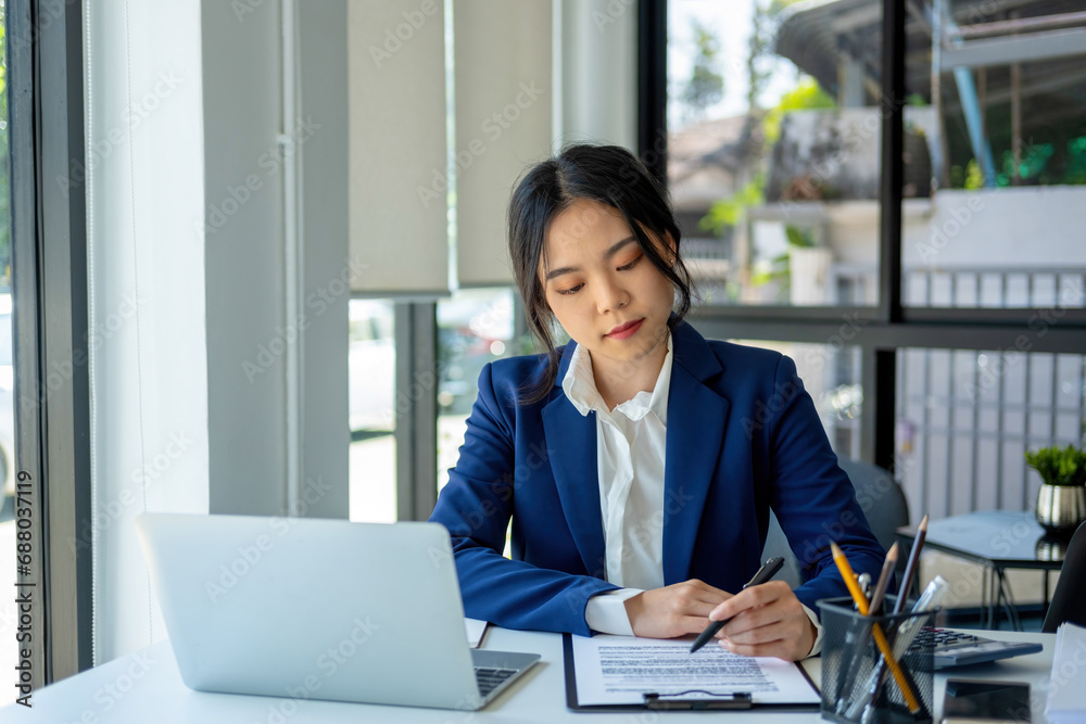 Busineswoman working by using laptop. Busineswoman working by using laptop.