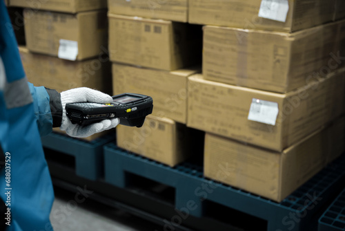 Bluetooth barcode scanner checking goods in the cold room or warehouse. photo