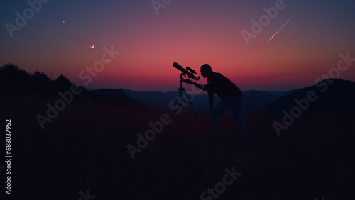 Astronomer looking at the stars, planets, Moon and celestial objects with a telescope.