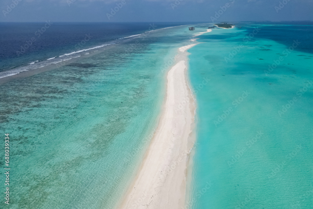 Obraz premium stunning blue ocean and sandy white island maldives top drone aeral view deserted hidden Maldives beach copyspace for text
