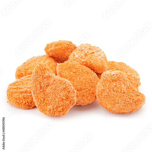 Spicy red chicken nuggets isolated on white background. Fried crunchy orange pieces of nuggets in heap.