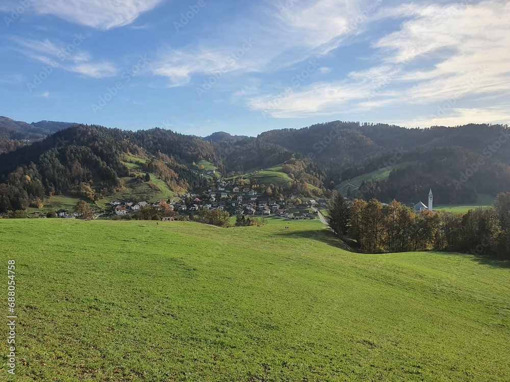 Beautiful slovenia: idyllic landscape with gently green rolling hills and a clear blue sky near Poljane nad Skofjo Loko