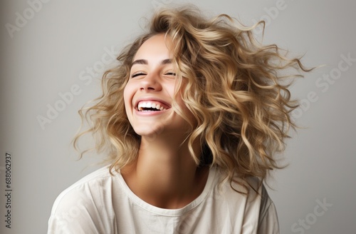 a young blonde woman is laughing,