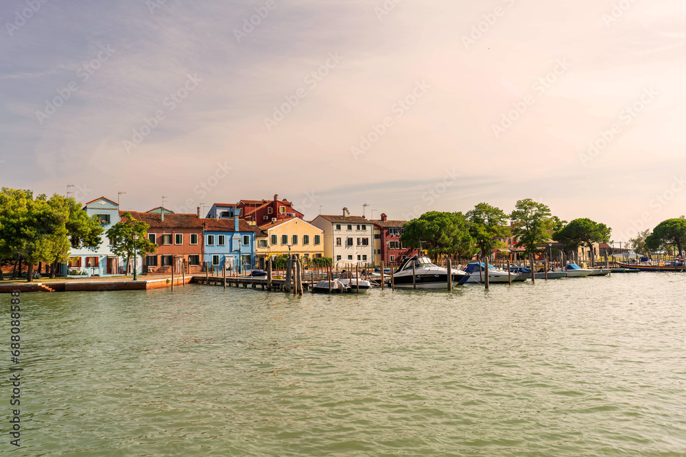 view of the town of Burano island colorful houses and port in venice italy