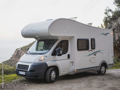 White over cab coachbuilt motor home outdoors