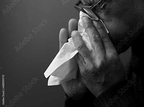 blowing nose after catching the cold and flu with grey background with people stock image stock photo photo