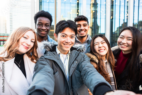 Multiracial people taking a selfie together and making funny faces