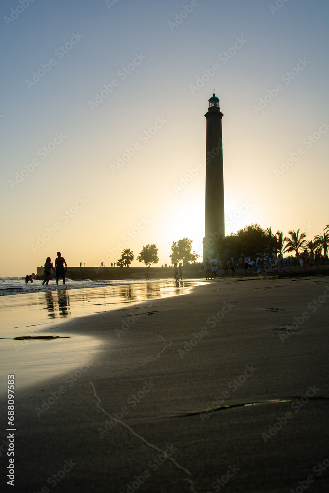 Lighthouse in Maspalomas, Gran Canaria, Spain at sunset with beach