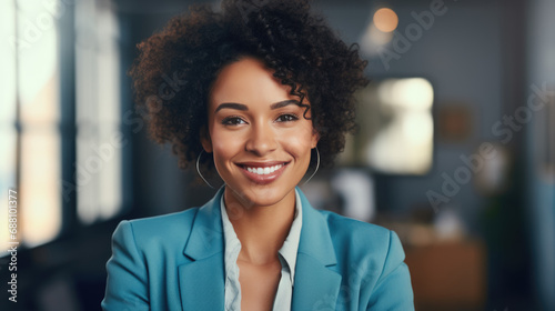 Close up portrait of a smiling businesswoman in suit standing against office background.