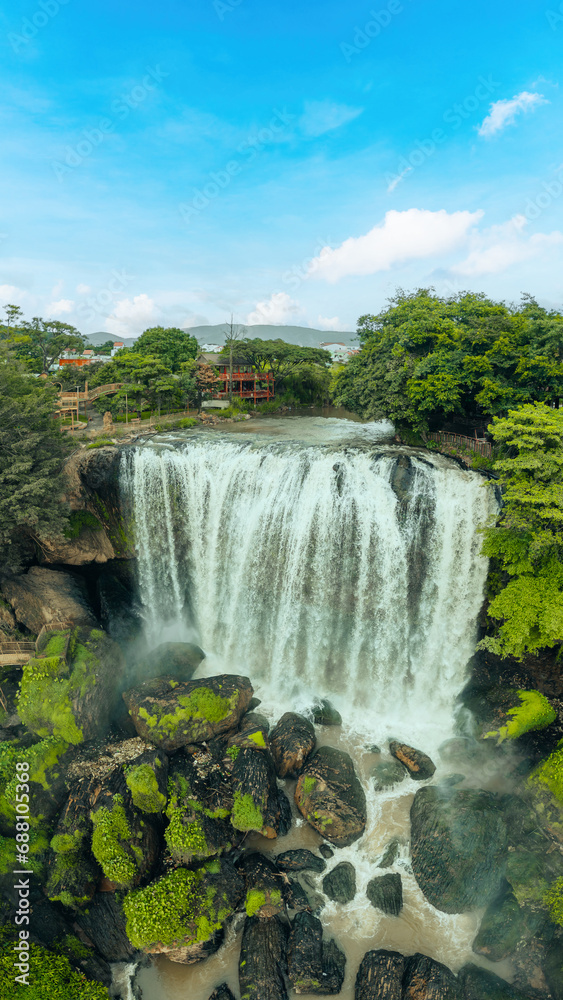 Aerial view of Thac Voi - Elephant waterfall, forest and city scene near Dalat city and Linh An pagoda in Vietnam