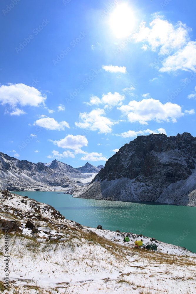 Obraz premium Ala-köl mountain lake with fresh snow during summer in Tian Shan mountains, Karakol, Kyrgyzstan