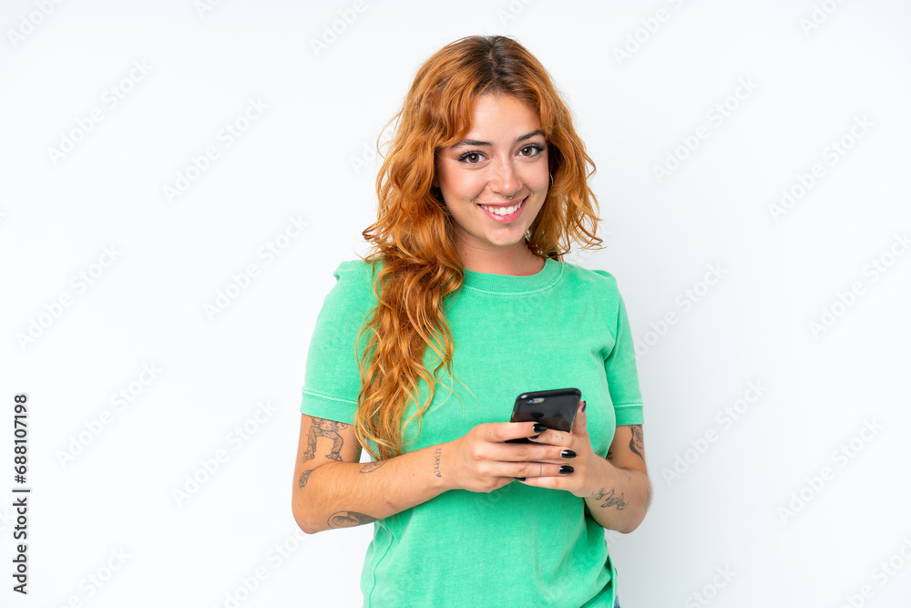 Young caucasian woman isolated on white background sending a message with the mobile Young caucasian woman isolated on white background sending a message with the mobile
