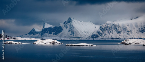 Dramatic winter scene of Lofoten Islands with Fredvang bridge on background. Panoramic morning view of Norway, Europe. Beauty of nature concept background..