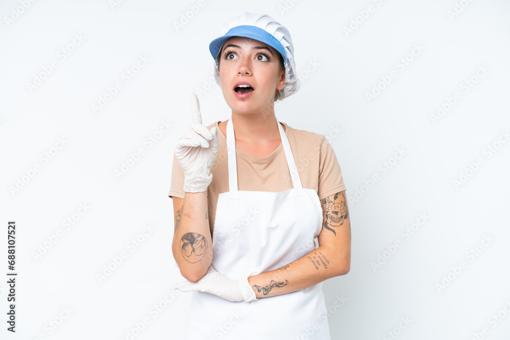 Fishmonger wearing an apron and holding a raw fish isolated on white background thinking an idea pointing the finger up Fishmonger wearing an apron and holding a raw fish isolated on white background thinking an idea pointing the finger up