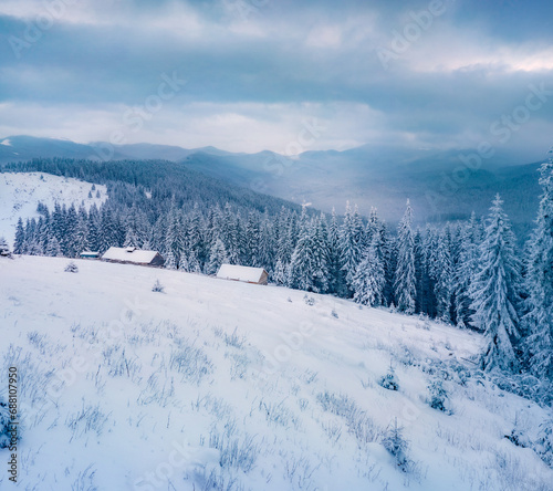 Dramatic winter view of abandoned mountain village. Gloomy morning scene of snowy forest. Spectacular landscape of Carpathian mountains  Ukraine  Euroepe.