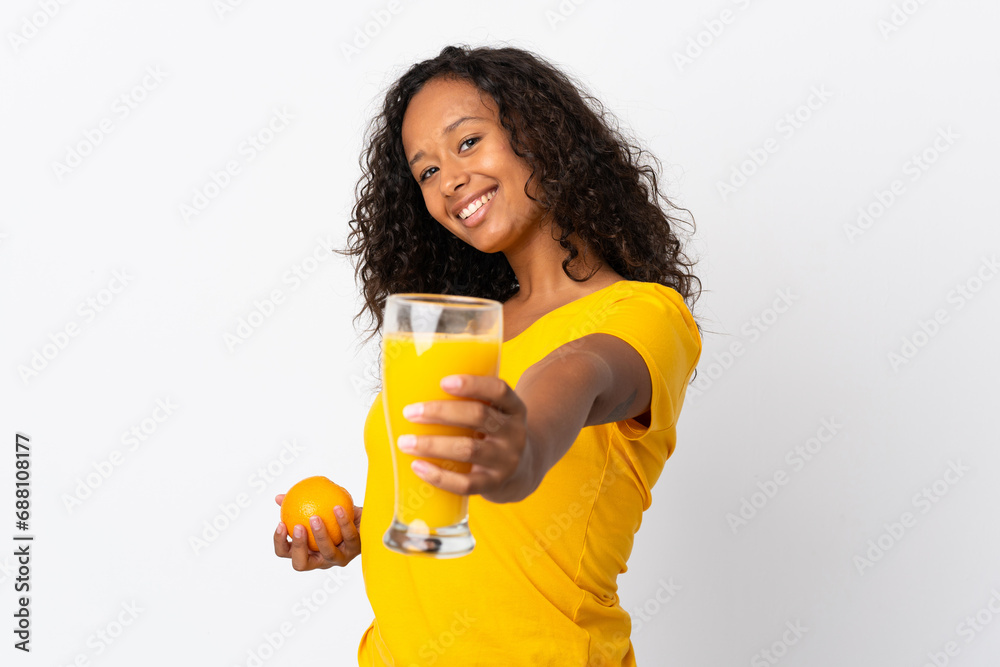 Teenager cuban girl isolated on white background holding an orange and an orange juice Teenager cuban girl isolated on white background holding an orange and an orange juice