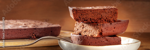 фотографія Chocolate brownie panorama, simple coffee cake, a side view shot on a dark rusti