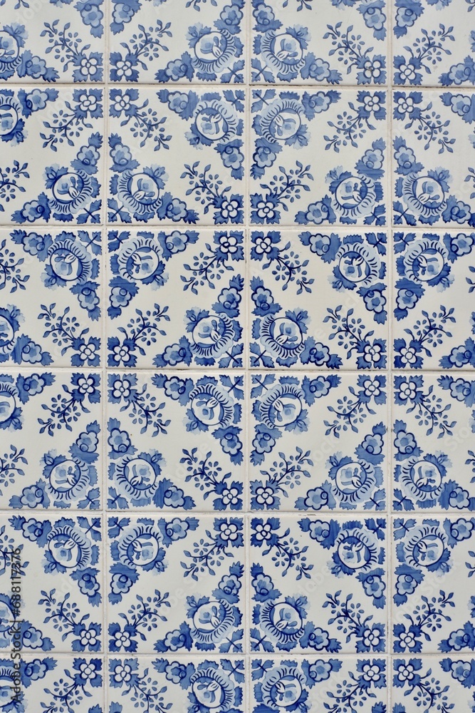 Traditional Portuguese tiles azulejos of blue colour with vintage ornate in Porto, Portugal