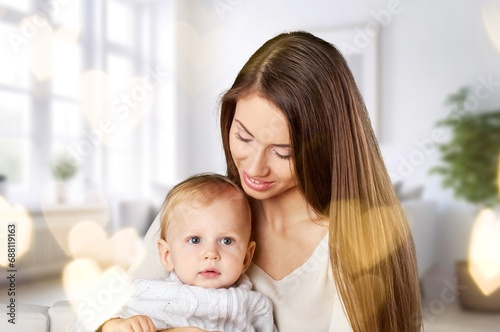 Loving mother have fun with little baby at home