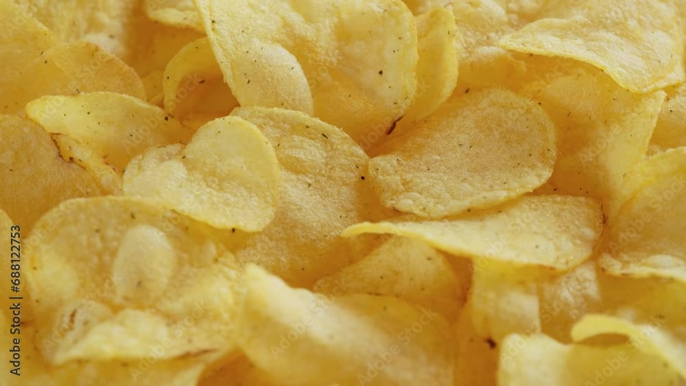 Macro view of potato chips spinning close up. Golden fried potatoes, Junk food Macro view of potato chips spinning close up. Golden fried potatoes, Junk food