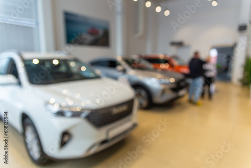 Blurred new car parked in modern showroom waiting for sales.