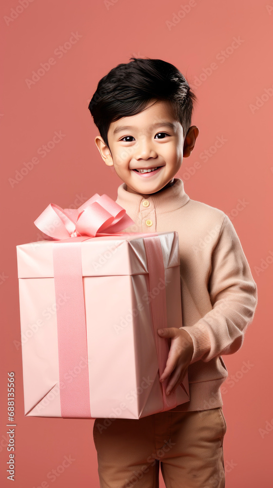 cute little boy giving happy expression while holding gift box. cute little boy giving happy expression while holding gift box.