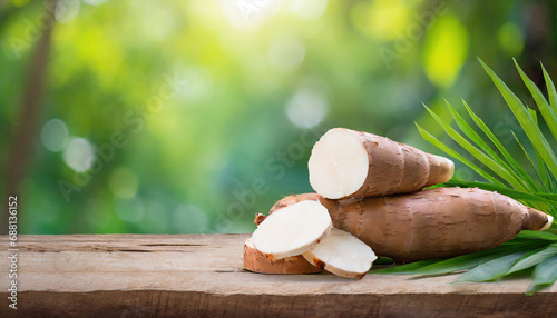 cassava on wood with a blurred green background photo