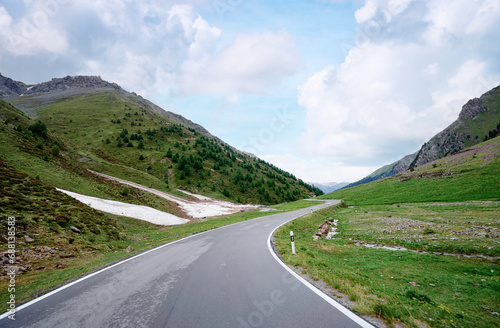 Asphalt road in Alps mountains. Road trip concept. Beautiful landscape.