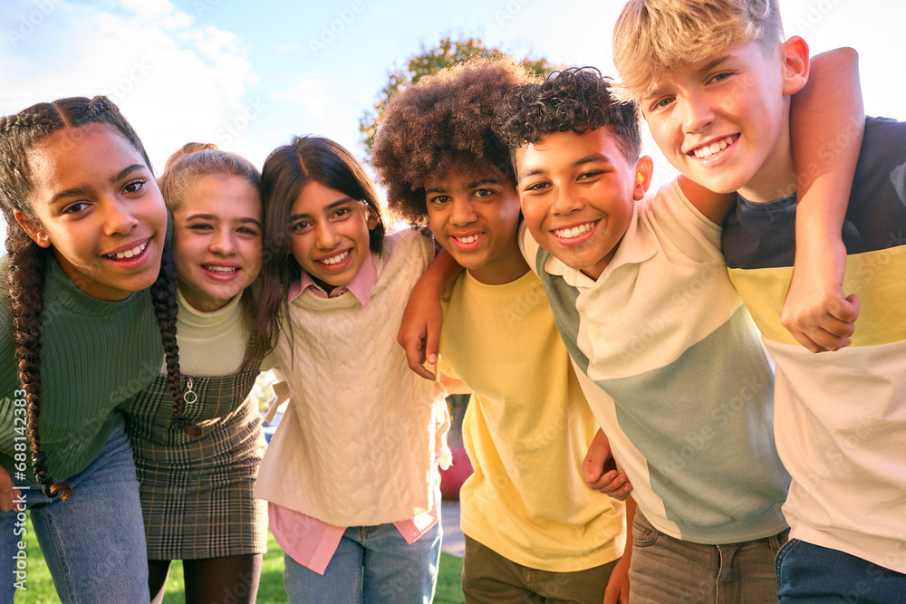 Portrait Showing Class Of Secondary Or High School Pupils Standing Outside School Building Hugging Portrait Showing Class Of Secondary Or High School Pupils Standing Outside School Building Hugging