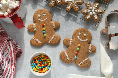 Baking and decorating gingerbread man cookies for a winter holiday Christmas party