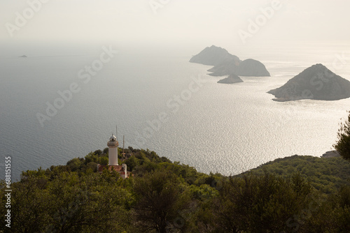 view from the top of the mountain on the lighhouse and the islands in the ocean photo