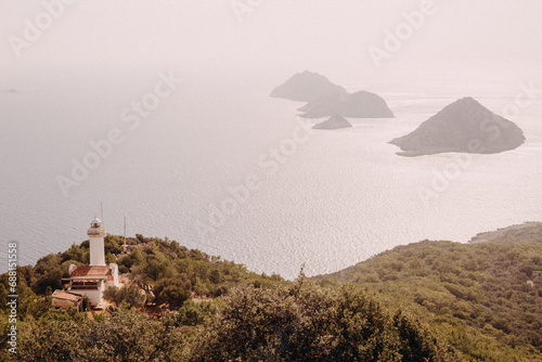 view from the top of the mountain on the lighhouse and the islands in the sea photo