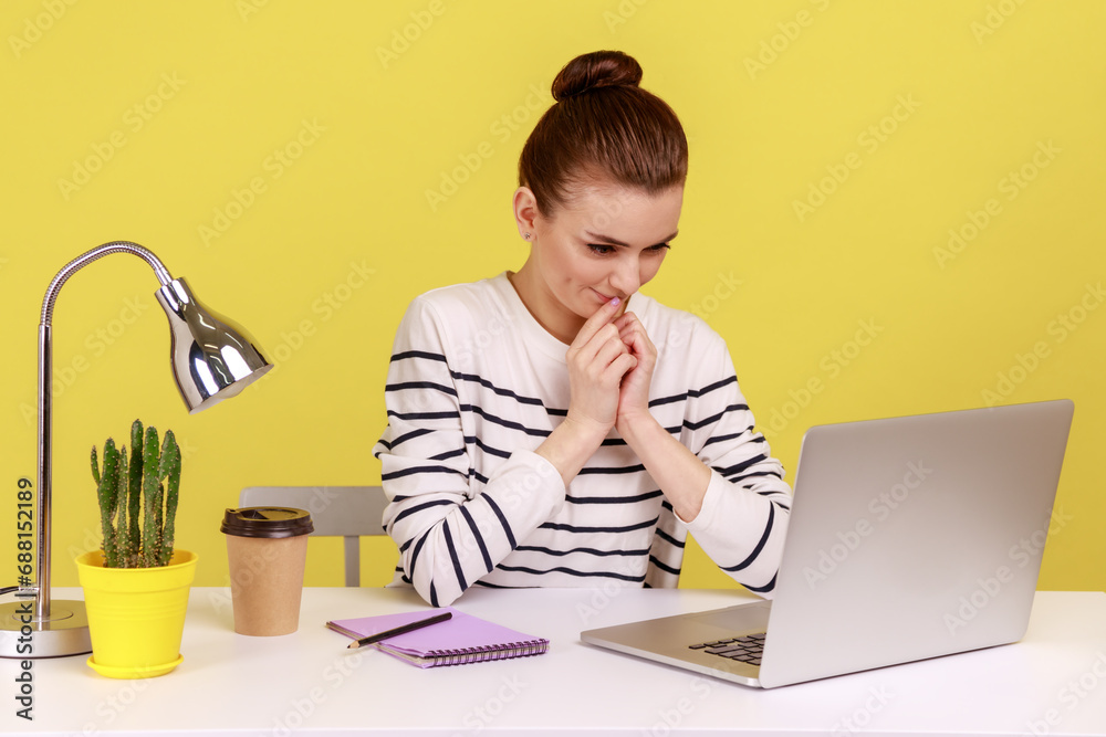 Cunning woman manger with tricky face scheming and conspiring, pondering devious plan while working on laptop, talking on video call Indoor studio studio shot isolated on yellow background. Cunning woman manger with tricky face scheming and conspiring, pondering devious plan while working on laptop, talking on video call Indoor studio studio shot isolated on yellow background.